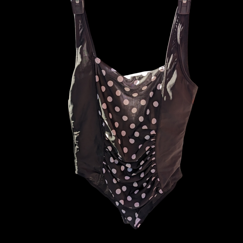 Swimsuit, black with white polka dots.